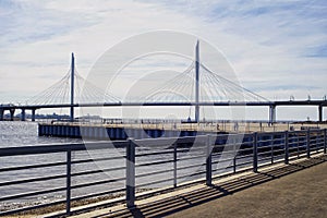 bridge metal fence embankment blue sky sunlight sea