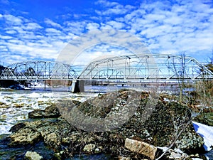 A bridge of metal structure over a river