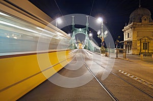 Bridge by night with blurred motion tram