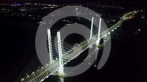 Bridge night illuminated logistic industrial highway crossing sea movement car aerial panorama view