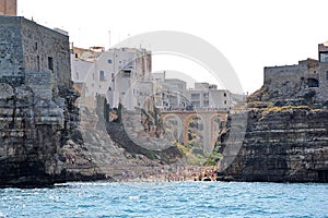 bridge over the beach, bay in Polignano a Mare Simple white buildings in the south of Italy, beach between the rocks