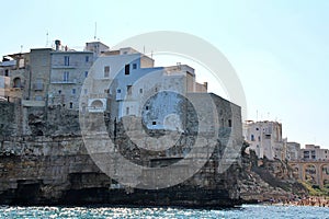 bridge over the beach, bay in Polignano a Mare, simple white buildings in the south of Italy, flat rocks on the coast