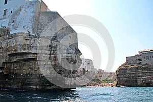 bridge over the beach, bay in Polignano a Mare, simple white buildings in the south of Italy, flat rocks on the coast