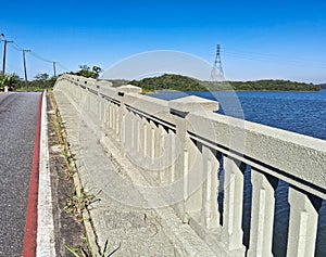Bridge over a blue water dam, on a sunny day with blue skies photo