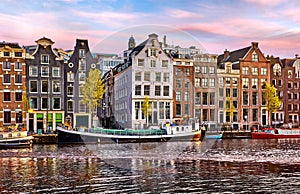 Bridge over channel in Amsterdam Netherlands houses river Amstel landmark old european city spring landscape.