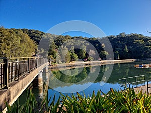 Bridge over Cockle Creek at Bobbin Head Reflected in the Water