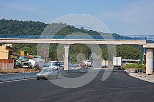 Bridge over country asphalt road with beautiful scenery on a sunny day