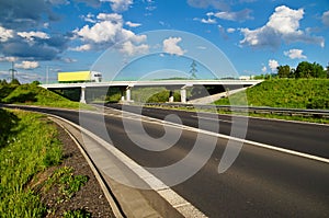 Bridge over an empty highway, going over the bridge truck