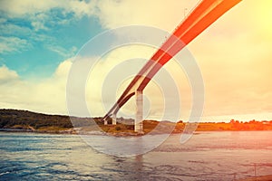 Bridge over fjord at sunset