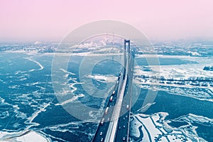 Bridge over the frozen river. Kiev city in the blizzard