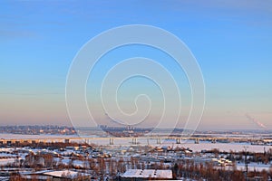 Bridge over frozen river and panoramic view of city