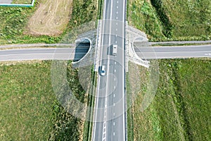 Bridge over highway road. sunny countryside landscape. aerial top view