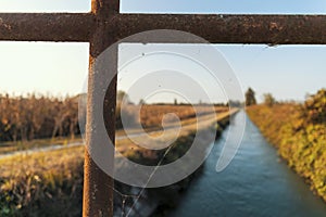 Bridge over an irrigation channel of the Lomellina at sunset