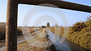 Bridge over an irrigation channel of the Lomellina at sunset