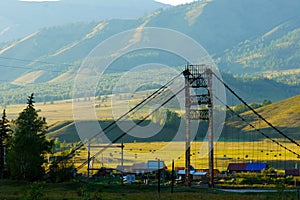 Bridge over Katun river and village Tungur