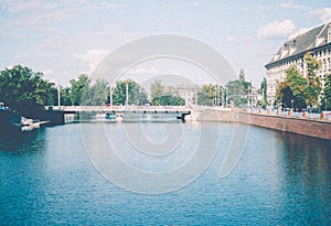 Bridge over Odra river in Wroclaw, Poland. Sunny summer afternoon. Grainy filter. Retro colors