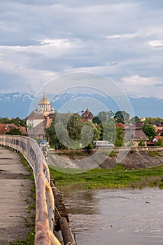 Bridge over the Olt river, view of the orthodox cathedral: Fagaras, Brasov County, Romania