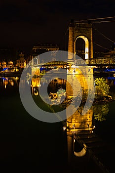 Bridge over Rhone river in Lyon, France at night