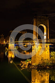 Bridge over Rhone river in Lyon, France at night