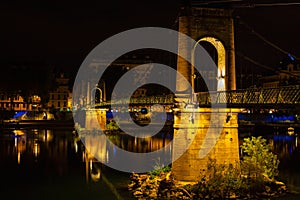 Bridge over Rhone river in Lyon, France at night