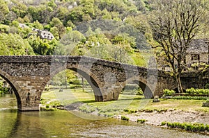 Bridge over the river Aveyron in the Villa Belcastel