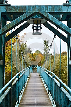 Bridge over the river. Bridge in the forest. Crossing the water in the countryside. Metal bridge for people in rural areas through