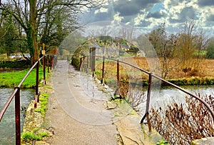 A bridge over the river Coln to the weavers cottages at Arlington Row