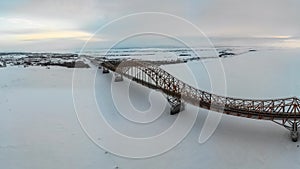Bridge over the river in the ice in winter. The oil-yugan bridge over the region