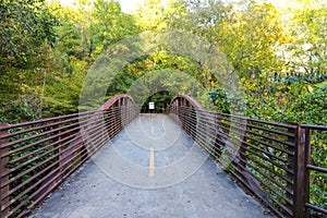 A bridge over a river with metal railing and lush green trees at the Chattahoochee River National Recreation Area