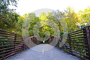 A bridge over a river with metal railing and lush green trees at the Chattahoochee River National Recreation Area