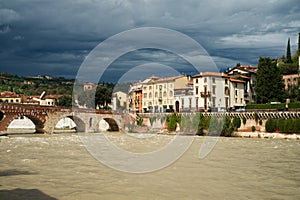 Bridge over the river in Verona Italy Ponte Pietra dramatic Adige river