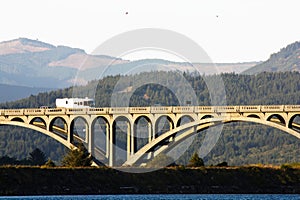 Bridge Over Rogue River Oregon With Hills And Sky