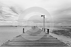 Bridge over the sea during ebb tide in black and white