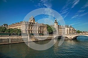 Bridge over the Seine River and the Conciergerie building with sunny blue sky at Paris.