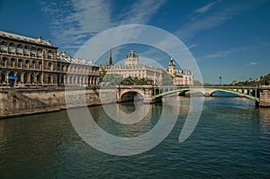 Bridge over the Seine River and the Conciergerie building with sunny blue sky at Paris.