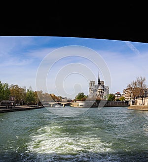 The bridge over Seine river frames Notre Dame Cathedral. Before the fire. April 05, 2019. Paris France