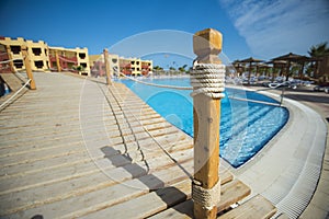 Bridge over swimming pool at tropical hotel resort