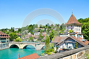 Bridge over turquoise Aare River in the historical old town of the Swiss capital Bern. Historical buildings along the river.