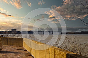 A bridge over the vast waters of the Mississippi river with blue sky and powerful clouds at sunset at Mud Island Park