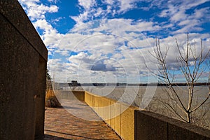 A bridge over the vast waters of the Mississippi river with blue sky and powerful clouds at sunset at Mud Island Park