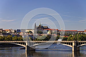 Bridge over the Vltava river in Prague on a nice summer day with the Saint Vitus cathedral and Prague castle in the background