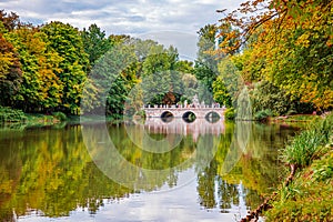 Bridge in the park on the lake. Royal Palace on the Water in Lazienki Park, Warsaw. Lake view in autumn