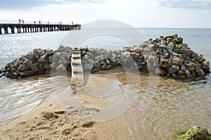 Bridge on a pile of rocks in the sea