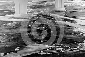 Bridge pillars in the cold water abstract black and white background