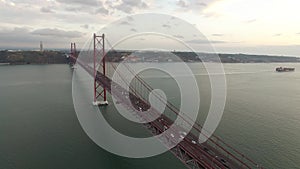 Bridge Ponte 25 de Abril over the Tagus river in Lisbon, Portugal at evening aerial view