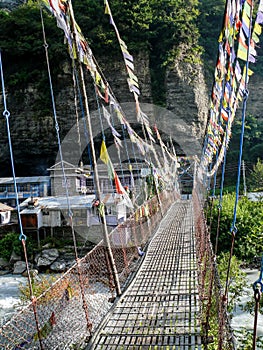 Bridge with prayer flags over Marsyangdi river Chame, Nepal