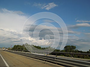 Bridge Rail overpass under blue sky with storm clouds