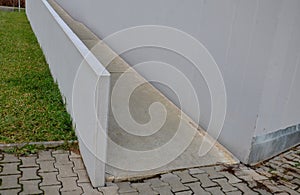 a bridge railing with vertical fence posts anchored into the ground