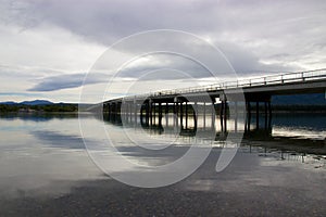 Bridge reflecting in lake in Tagish, Yukon, Canada