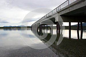 Bridge reflecting in lake in Tagish, Yukon, Canada